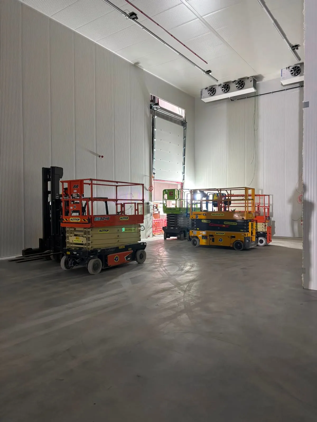 Rij palletstellingen met grijze staanders en oranje liggers in een hoogbouwmagazijn